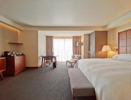 a hotel room with a bed and a desk at Grand Fiesta Americana Chapultepec in Mexico City
