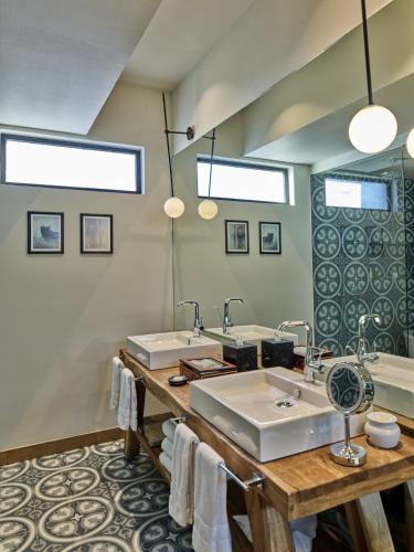 a bathroom with two sinks and a large mirror at Live Aqua San Miguel de Allende in San Miguel de Allende
