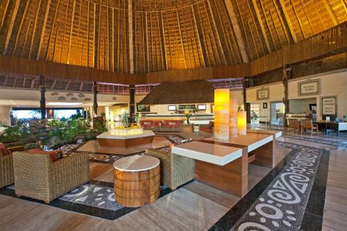 a lobby with tables and chairs in a resort at Fiesta Americana Puerto Vallarta All Inclusive & Spa in Puerto Vallarta