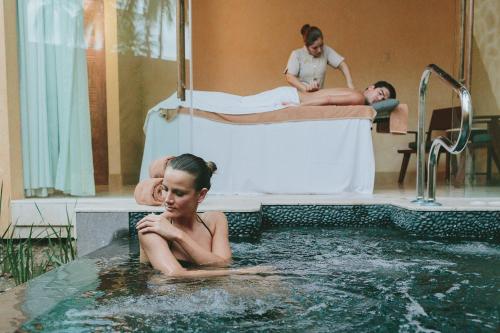 a woman laying in a swimming pool in a hospital bed at Fiesta Americana Puerto Vallarta All Inclusive & Spa in Puerto Vallarta
