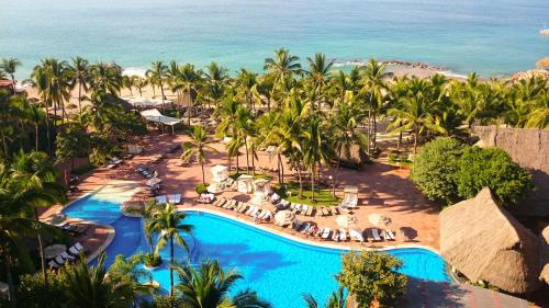 an aerial view of a resort with a pool and the ocean at Fiesta Americana Puerto Vallarta All Inclusive & Spa in Puerto Vallarta