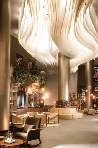 a lobby with large chandeliers hanging from the ceiling at Live Aqua Ciudad de Mexico Bosques de las Lomas in Mexico City