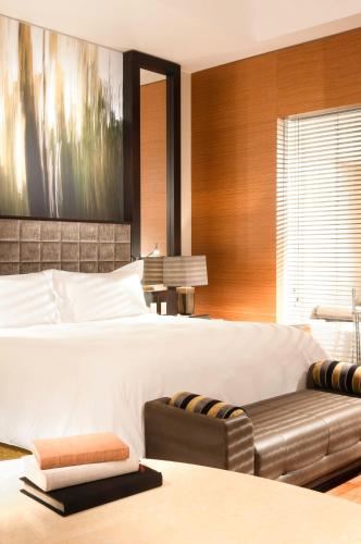 a bedroom with a large bed and a couch at Live Aqua Ciudad de Mexico Bosques de las Lomas in Mexico City