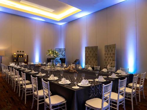 a long table with chairs in a room at Live Aqua Ciudad de Mexico Bosques de las Lomas in Mexico City