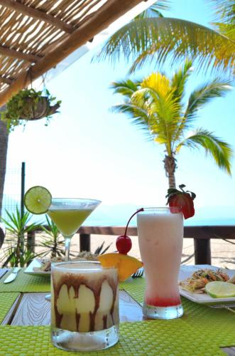 two cocktails on a table with a view of the ocean at Fiesta Americana Puerto Vallarta All Inclusive & Spa in Puerto Vallarta