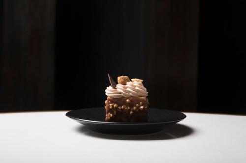 a chocolate dessert on a black plate on a table at Live Aqua Ciudad de Mexico Bosques de las Lomas in Mexico City