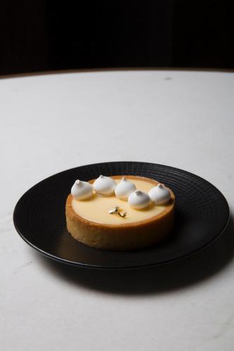 a cake on a black plate on a table at Live Aqua Ciudad de Mexico Bosques de las Lomas in Mexico City