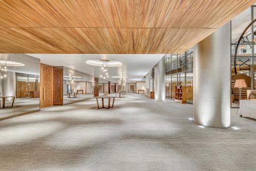 a lobby with a wooden ceiling and tables and chairs at Live Aqua Ciudad de Mexico Bosques de las Lomas in Mexico City