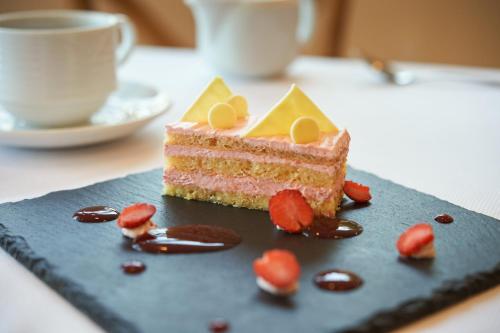 a piece of cake on a blue plate with strawberries at Grand Fiesta Americana Veracruz in Veracruz