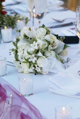 a vase filled with white flowers on a table at Grand Fiesta Americana Guadalajara Country Club in Guadalajara