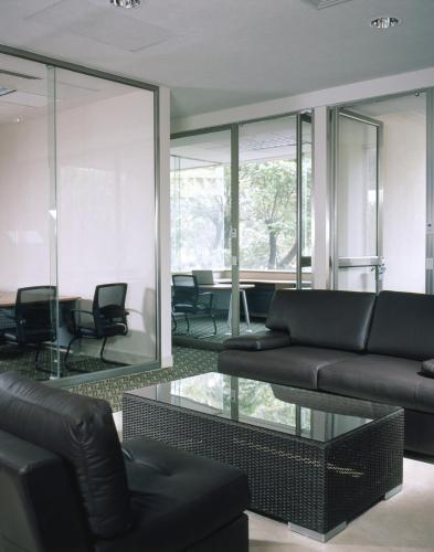 a living room with a couch and a table and chairs at Grand Fiesta Americana Guadalajara Country Club in Guadalajara