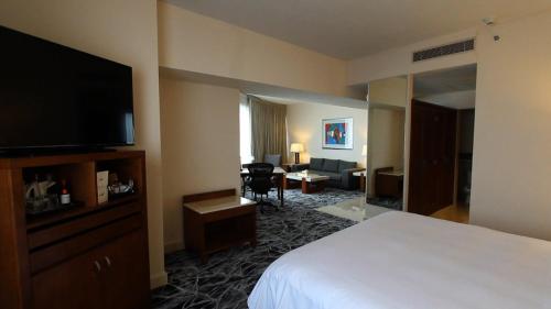 a hotel room with a bed and a television at Grand Fiesta Americana Guadalajara Country Club in Guadalajara