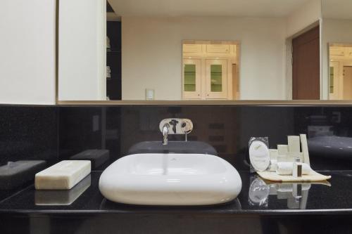 a bathroom with a white sink and a mirror at Grand Fiesta Americana Guadalajara Country Club in Guadalajara