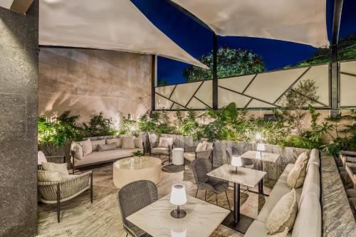 a lobby with couches and tables and plants at Grand Fiesta Americana Guadalajara Country Club in Guadalajara