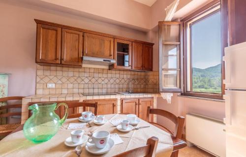 a kitchen with a table with a vase on it at 1 Bedroom Awesome Apartment In Montone in Montone