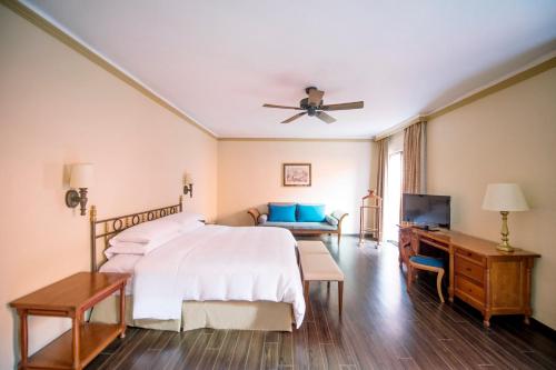 a hotel room with a bed and a television at Fiesta Americana Hacienda Galindo Resort & Spa in Galindo