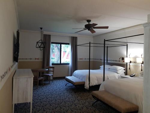 a hotel room with two beds and a ceiling fan at Fiesta Americana Hacienda Galindo Resort & Spa in Galindo