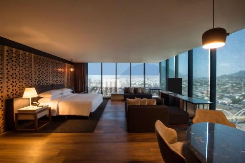 a hotel room with a bed and a view at Fiesta Americana Monterrey Pabellón M. in Monterrey