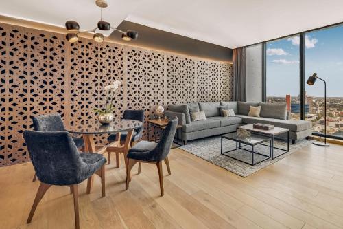 a living room with a couch and a table at Fiesta Americana Monterrey Pabellón M. in Monterrey