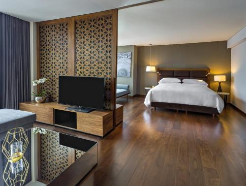 a bedroom with a bed and a television on a table at Fiesta Americana Mexico Toreo in Mexico City