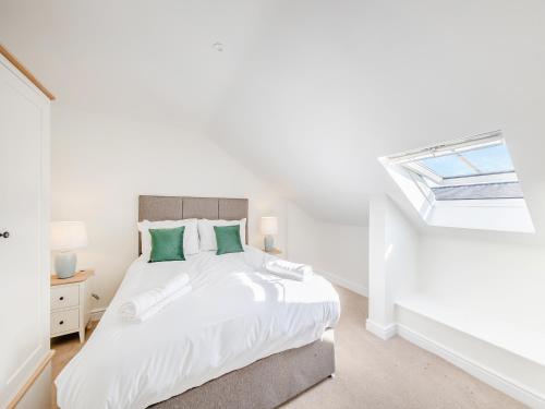 a bedroom with a white bed and a window at No 7 - Cheltenham - Uk47936 in Oswestry