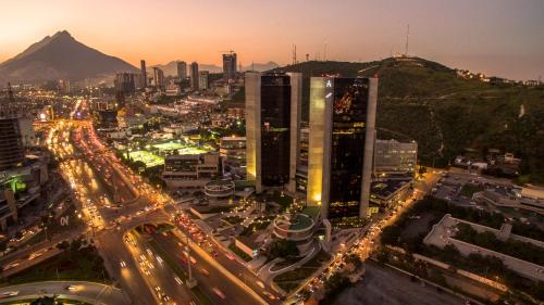a city with a lot of traffic at night at Live Aqua Monterrey in Monterrey