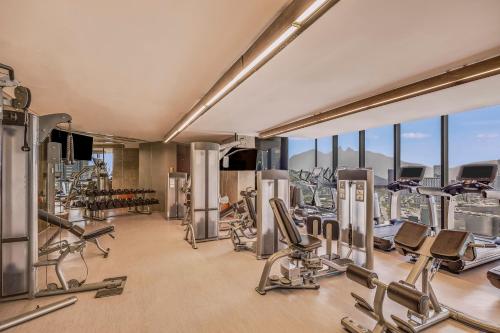 a gym with a lot of exercise equipment and windows at Live Aqua Monterrey in Monterrey