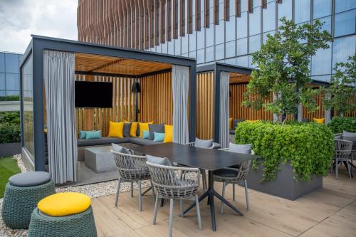 a patio with a table and chairs in front of a building at Fiesta Americana Viaducto Aeropuerto in Mexico City