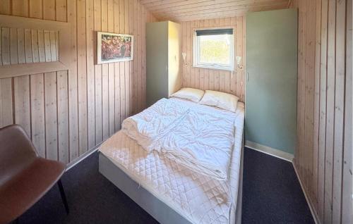 a small bedroom with a bed in the corner at Nice Home In Otterup With Kitchen in Otterup