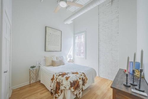 a white bedroom with a bed and a desk at Darlin Downtown Dawghouse in Athens