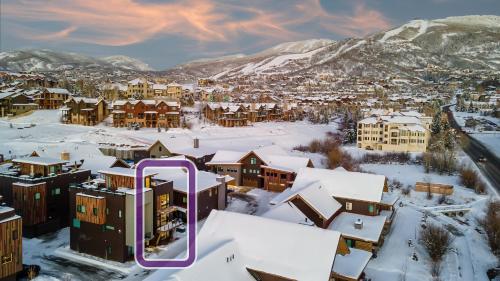 a city covered in snow with buildings and mountains at Metropolitan House in Steamboat Springs