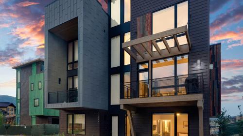 an apartment building with a sunset in the background at Metropolitan House in Steamboat Springs