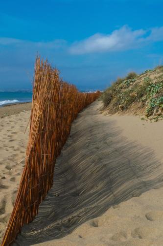 a fence on a sandy beach near the ocean at Hostal Casa Miguel Marbella in Marbella
