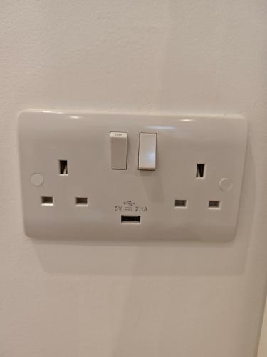 a white light switch on a white wall at Ashwood Stay in Galway