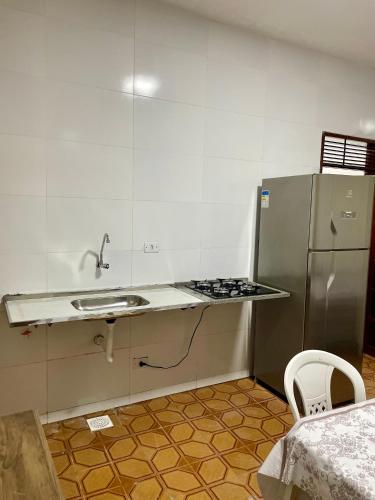 a small kitchen with a sink and a refrigerator at Caminho da promessa 02 centro ar cozinha in Juazeiro do Norte