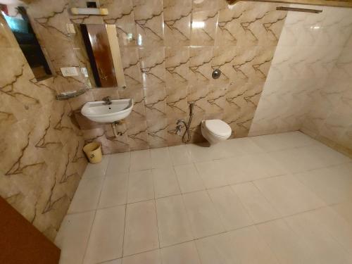 a bathroom with a sink and a toilet at Gir Jungle Lodge in Sasan Gir