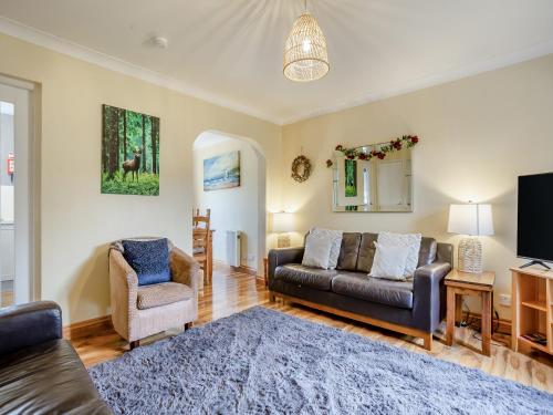 a living room with a couch and two chairs at Cairnie View in Aviemore
