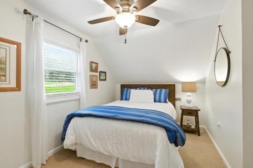 a bedroom with a bed and a ceiling fan at The Holiday House w Dock in Townville