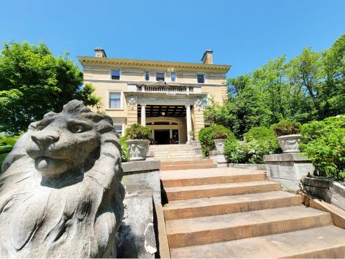 a statue of a lion in front of a building at Historic Cotton Mansion by Heirloom Boutique Collection in Duluth