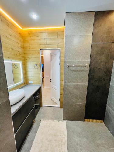 a bathroom with a sink and a toilet and a shower at Квартира 17-23 in Aktau