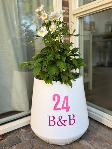 a flower pot with the number and b on it at De kleine Bongerd -The little Orchard in Hengelo