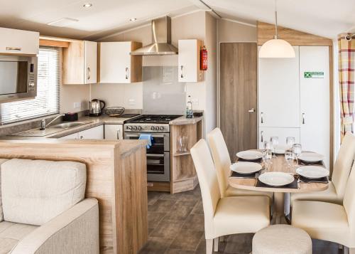 a kitchen and dining room with a table and chairs at Hanworth Country Park in Potter Hanworth