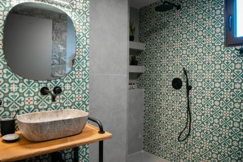 a bathroom with a sink and a mirror at Ξενώνας Αγανίππη 