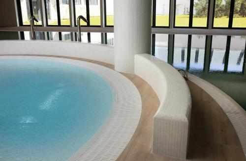 a large swimming pool in a building at Pinea Apartments in Pobierowo