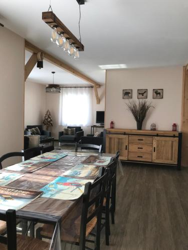 a living room with a large table and chairs at Maison "L' Ostal De Montanha" in Génos