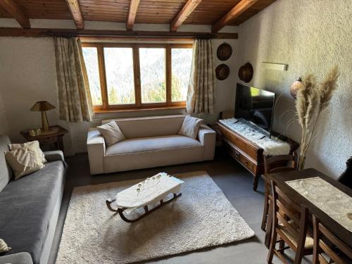 a living room with a couch and a table at Appartamento Marelè - Folgarida sky area Campiglio in Folgarida