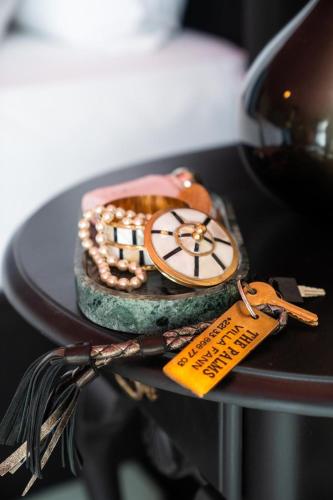 a clock sitting on top of a table with tags at The Palms Villa Luxury Boutique Hotel in Dakar