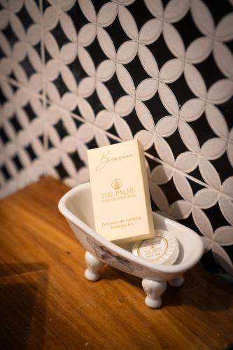 a small plate with a card in a bowl at The Palms Villa Luxury Boutique Hotel in Dakar