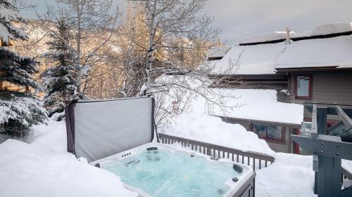 a hot tub on a balcony covered in snow at Orion Lodge in Steamboat Springs