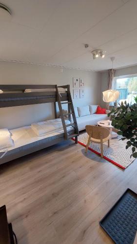a room with two bunk beds and a couch at 4 Bed apartment close to Branäs - Likemovägen 11C in Likenäs